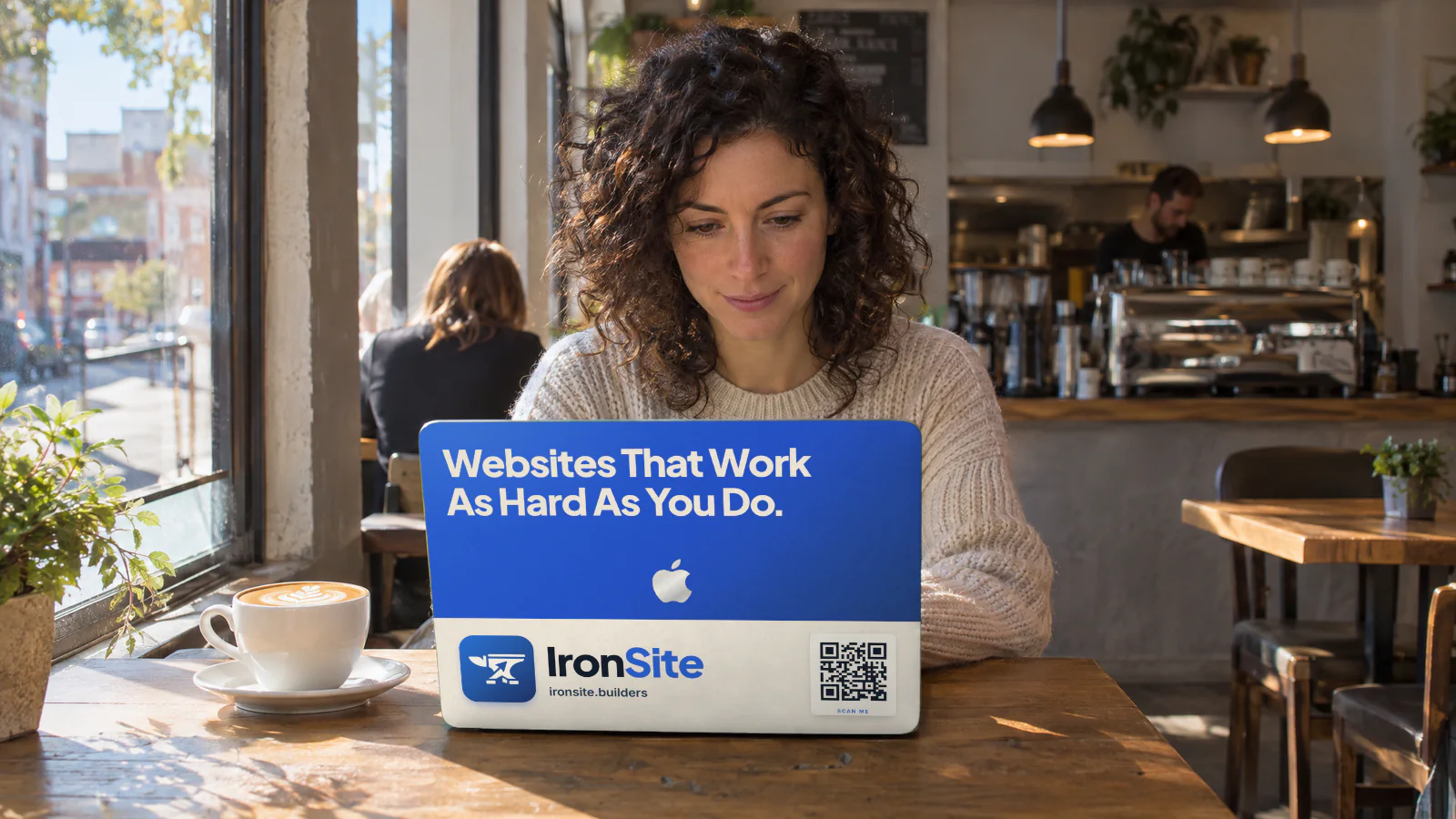 An IronSite Builders ad skin on a laptop in a coffee shop.