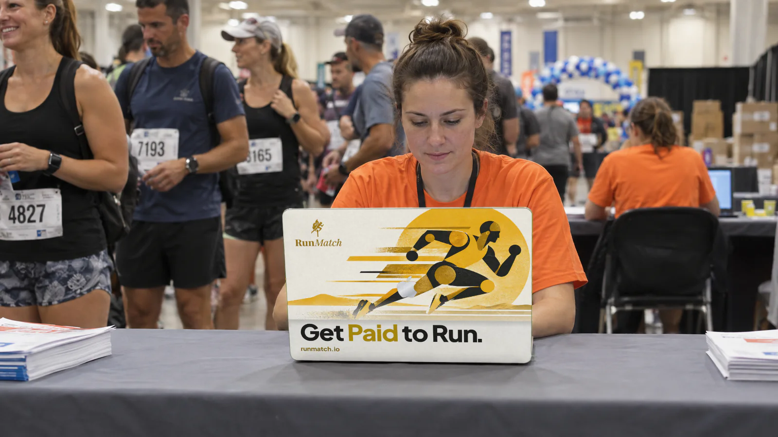 A RunMatch ad skin on a laptop at a marathon expo.